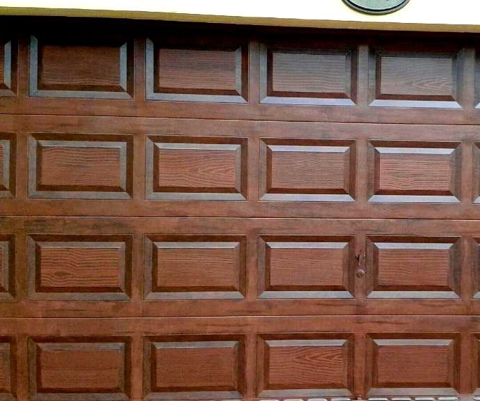Garage door with faux oak wood finish